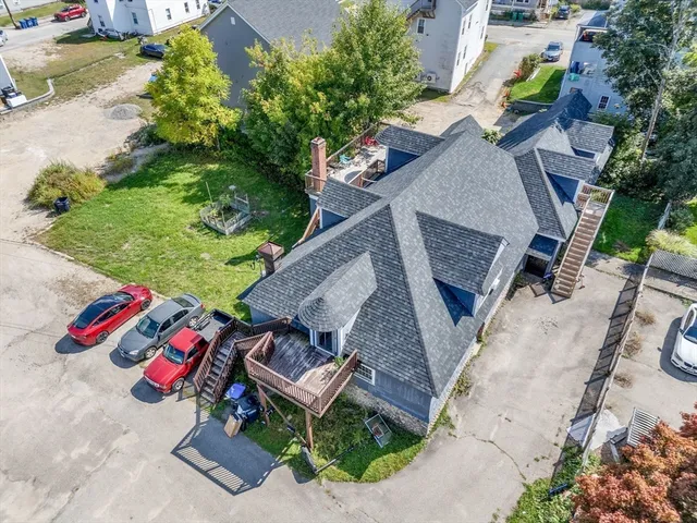an aerial view of a house with outdoor seating