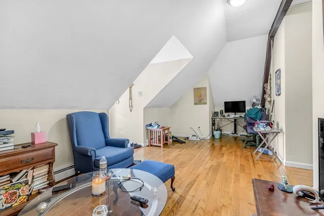 a living room with furniture or wooden floor and a flat screen tv