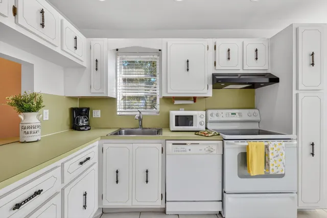 a kitchen with cabinets appliances and a sink