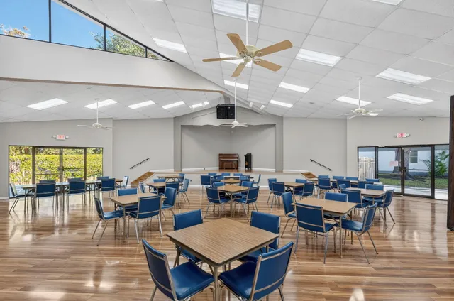a living room with furniture and a book shelf