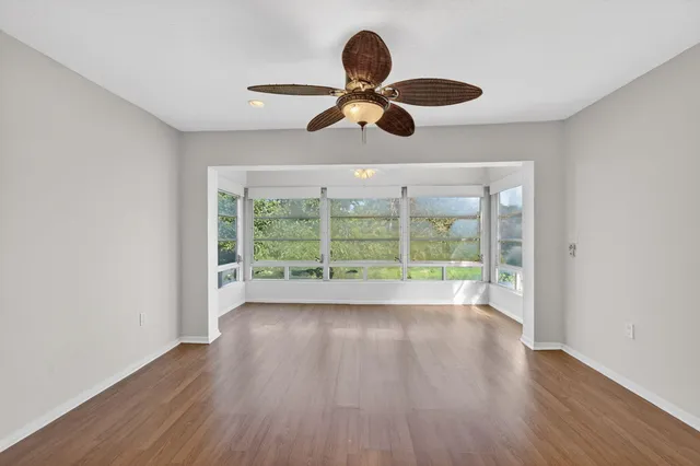 a view of room with wooden floor and chandelier