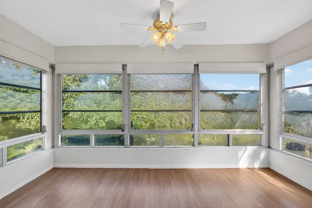 a view of wooden floor and windows in a room