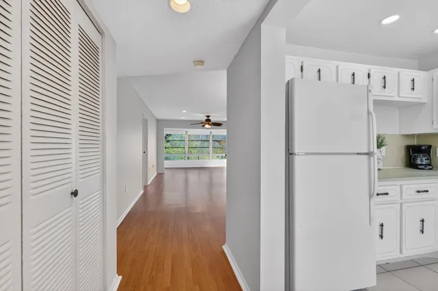 a white refrigerator freezer sitting inside of a kitchen
