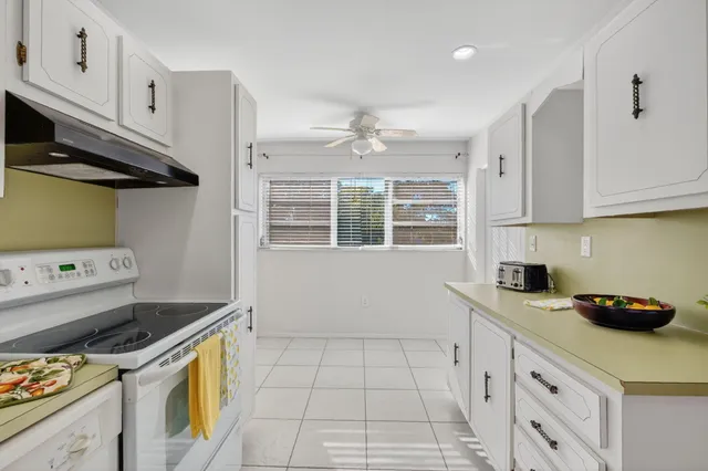 a kitchen with a sink a stove and cabinets