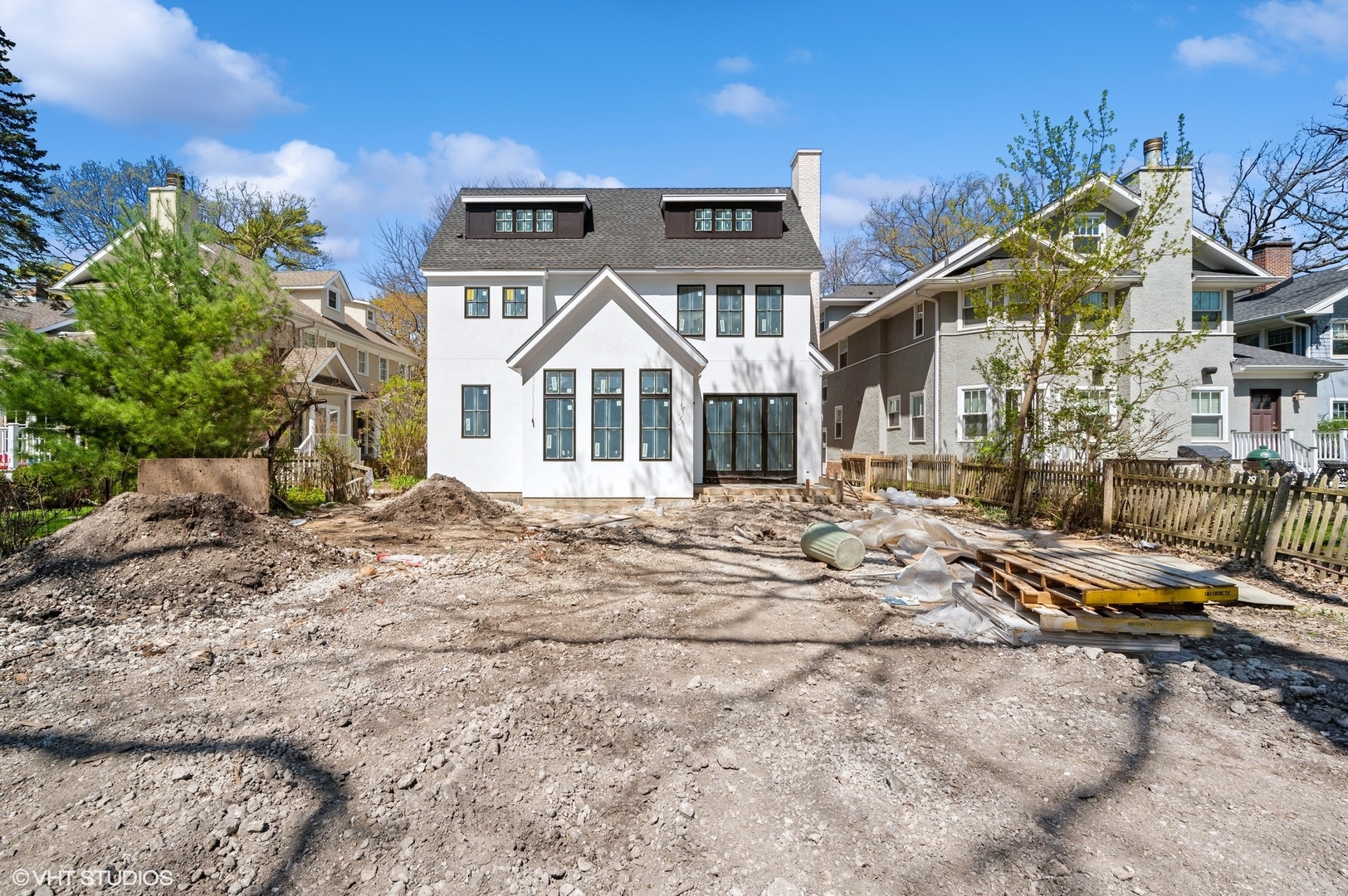 419 Laurel Avenue Wilmette, IL 60091 - Photo 3 of 6 a view of a white house with a yard and lawn chairs