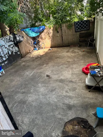 a view of a backyard with a table and a chair