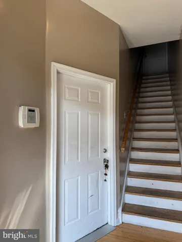 a view of a hallway with wooden floor and entryway
