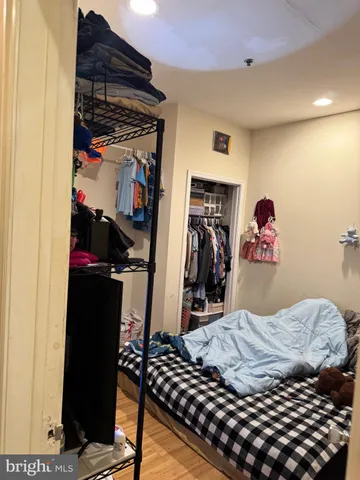 a bedroom with a bed and a walk in closet
