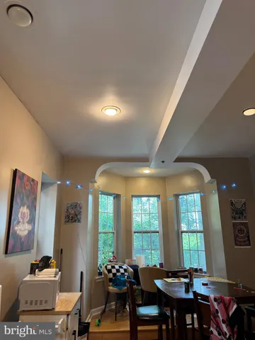 a view of a a dining room with furniture window and outside view