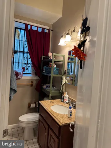 a bathroom with a sink vanity mirror and toilet