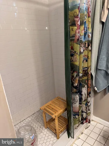 a bedroom with a bed and a wall painting