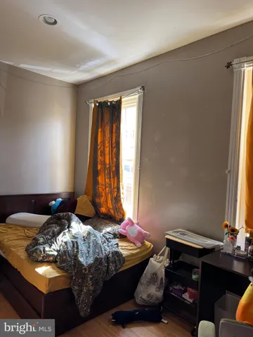 a view of a hallway with wooden floor and stairs
