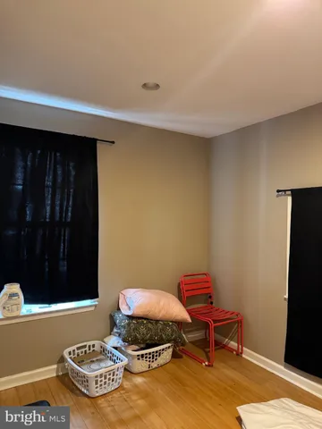 a bathroom with a granite countertop toilet sink and mirror