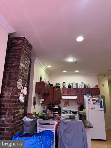 a kitchen with a sink and a stove top oven