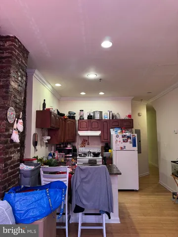 a kitchen with stainless steel appliances granite countertop a sink a stove a refrigerator and a microwave