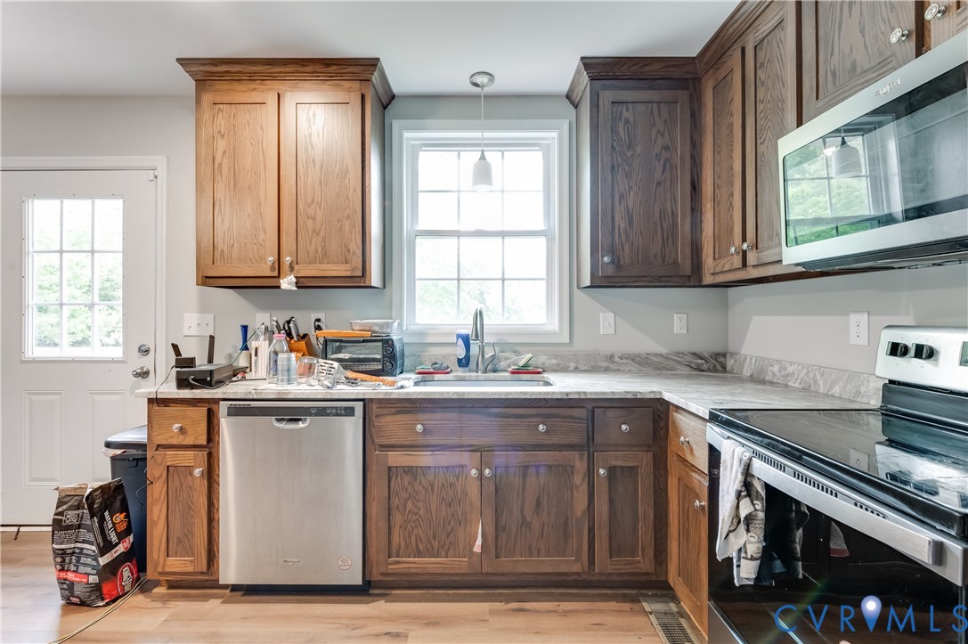 24580 St James Road Jetersville, VA 23083 - Photo 11 of 25 Kitchen featuring wood-finish cabinetry, light-ton