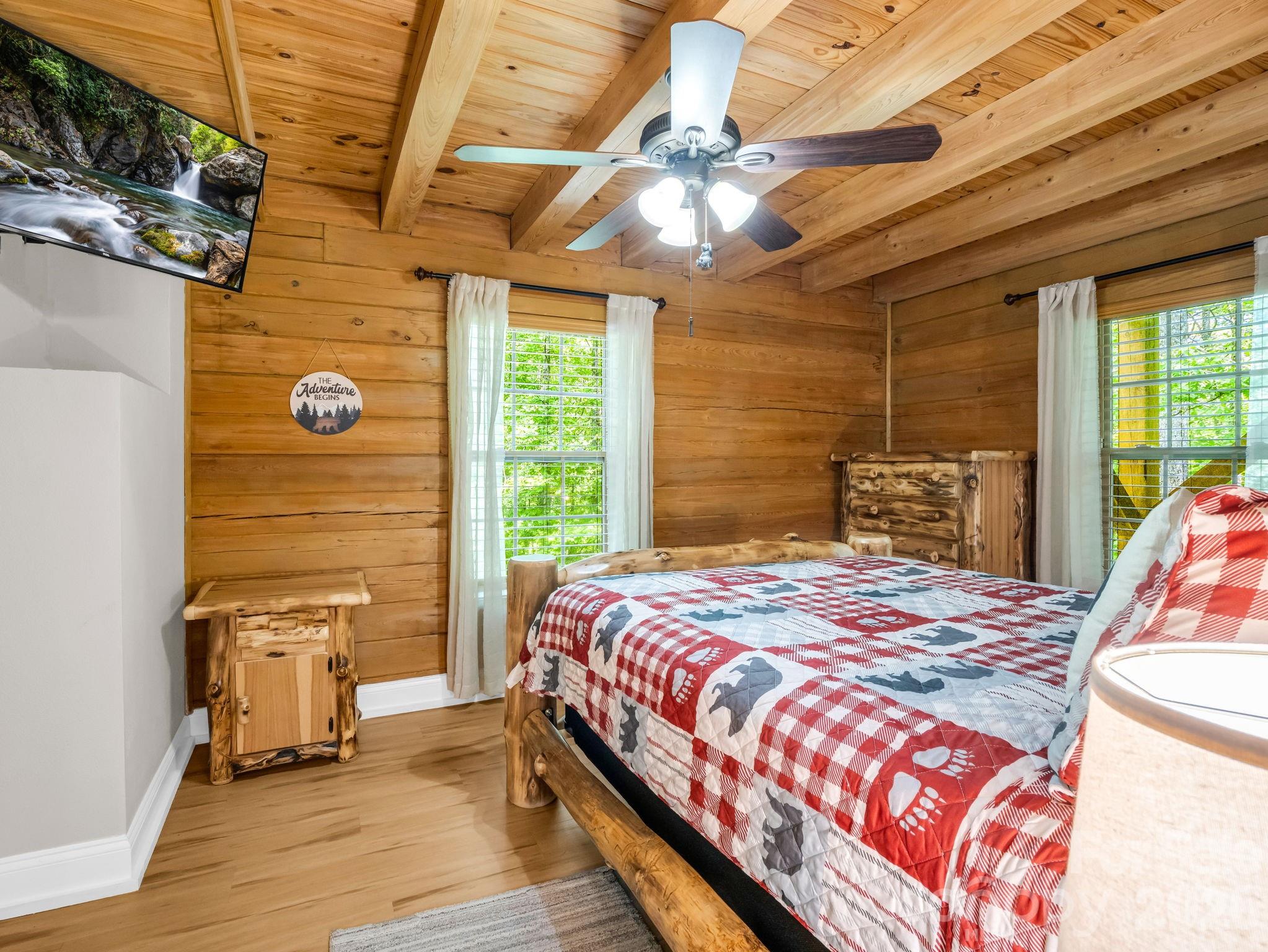 165 Dream Road Hendersonville, NC 28792 - Photo 19 of 46 a bedroom with a bed and wooden floor