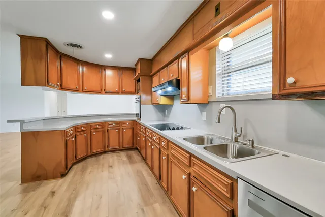 a kitchen with stainless steel appliances granite countertop a sink a stove and a microwave oven