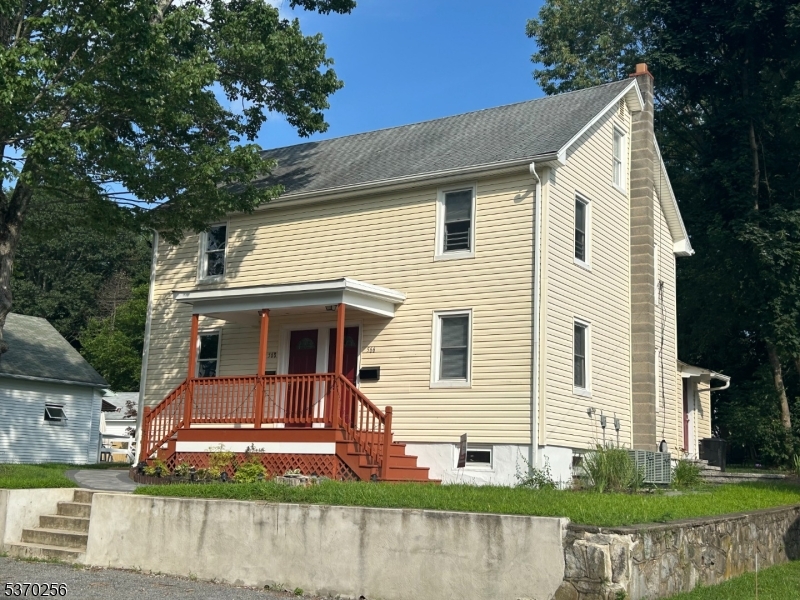 a view of a white house with a yard