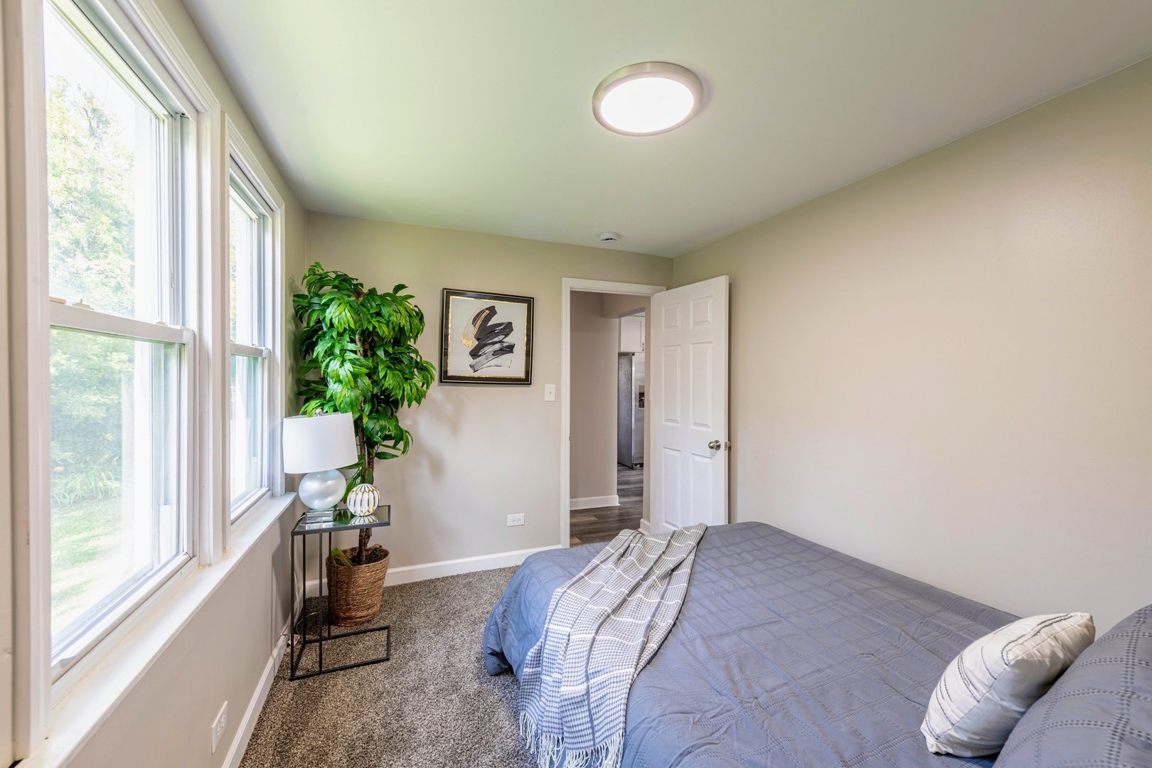 3340 Maple Avenue Brookfield, IL 60513 - Photo 16 of 26 a bedroom with a bed and a potted plant