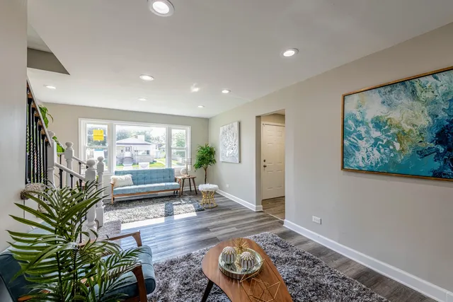 a living room with furniture and a potted plant