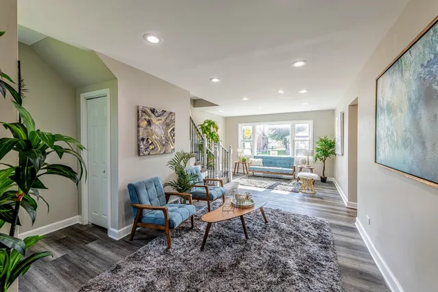 a living room with furniture and wooden floor