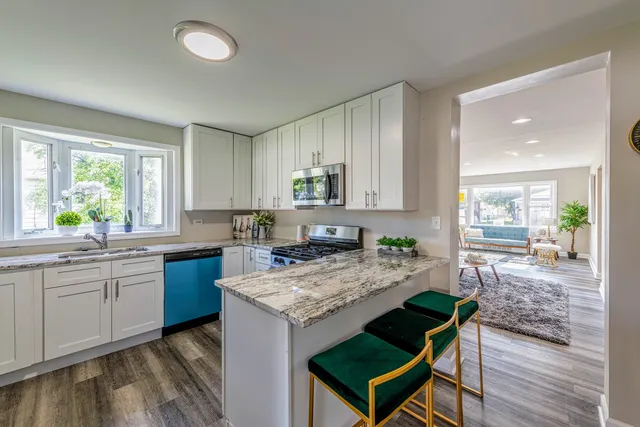 a kitchen with a stove a sink and a refrigerator
