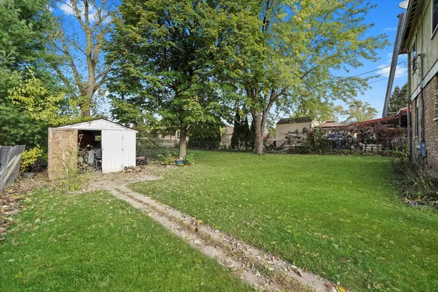 a view of a yard with a house and large trees