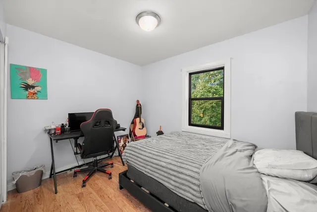 a bedroom that has a bed and a desk