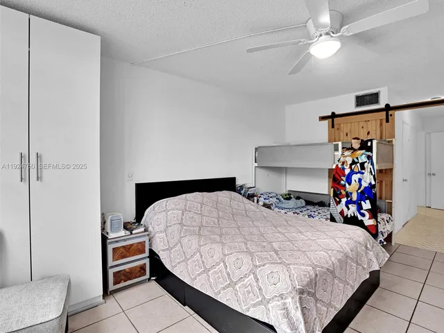 a bedroom with a bed a dresser and a baby