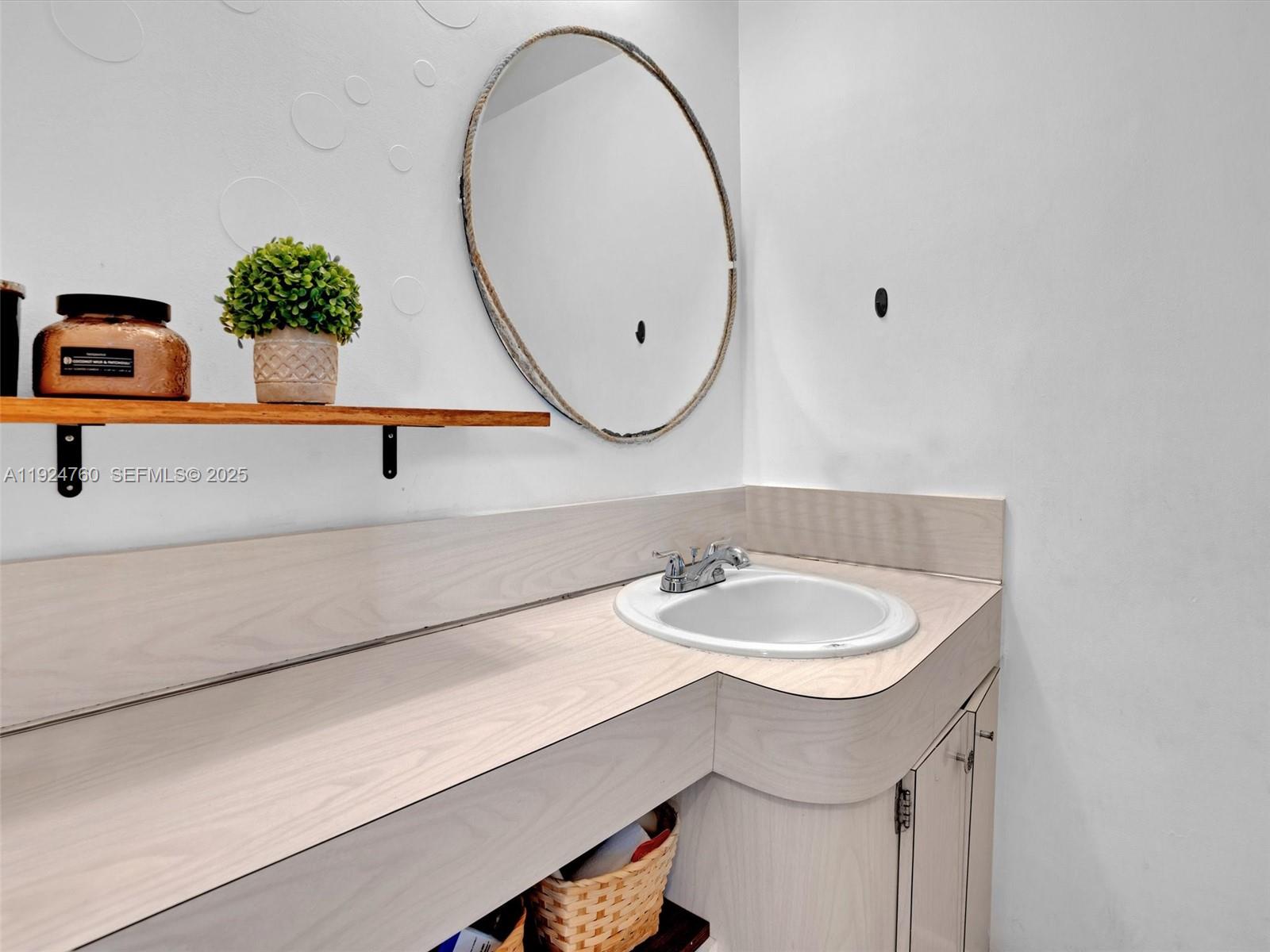 1780 Northeast 191st Street, Unit 2052 Miami, FL 33179 - Photo 28 of 51 a bathroom with a sink and a mirror