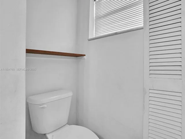 a bathroom with a sink a toilet and shower curtain