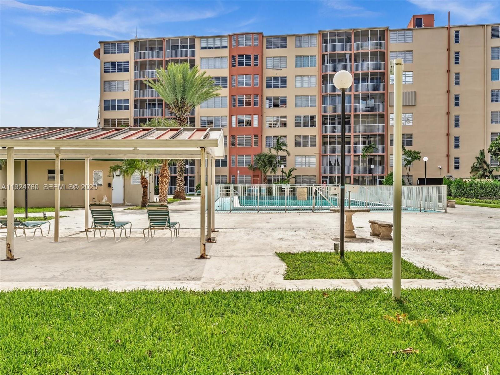 1780 Northeast 191st Street, Unit 2052 Miami, FL 33179 - Photo 32 of 51 a view of a building with a garden