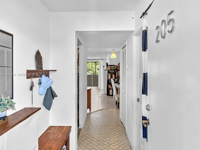 a view of a hallway with furniture and a living room