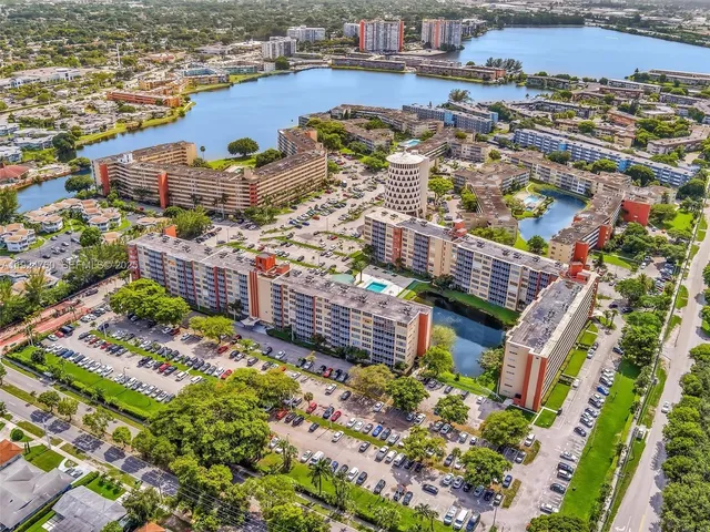 an aerial view of a house with a swimming pool patio and outdoor seating