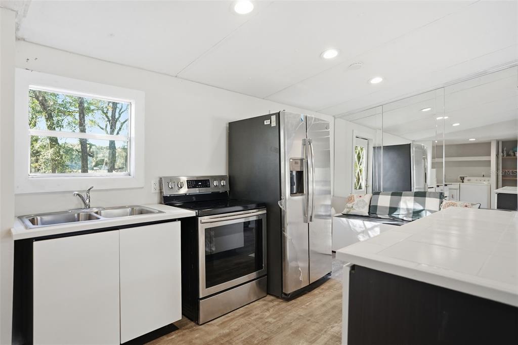 25256 Richbarn Road Brooksville, FL 34601 - Photo 12 of 32 a kitchen with a sink stove and refrigerator