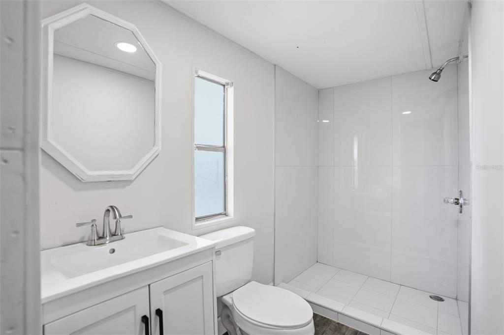 25256 Richbarn Road Brooksville, FL 34601 - Photo 17 of 32 a bathroom with a sink a toilet and shower