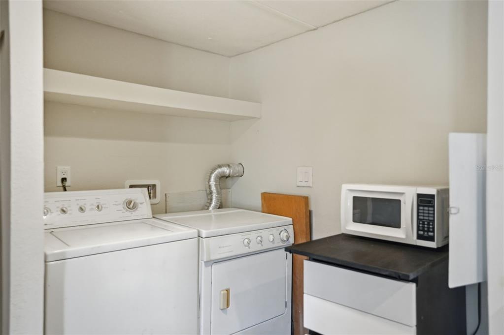 25256 Richbarn Road Brooksville, FL 34601 - Photo 21 of 32 a view of washer and dryer with kitchen in the background