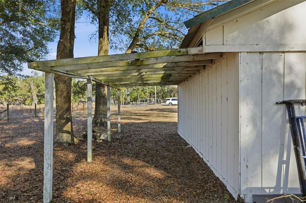 25256 Richbarn Road Brooksville, FL 34601 - Photo 22 of 32 a view of a patio with table and chairs under an umbrella