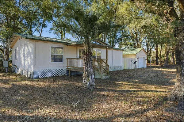 a view of a house with a tree in the background