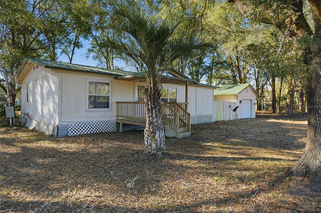 25256 Richbarn Road Brooksville, FL 34601 - Photo 3 of 32 a view of a house with a tree in the background