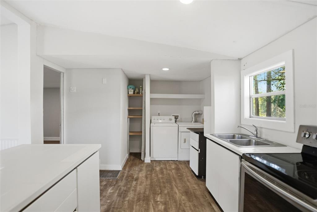 25256 Richbarn Road Brooksville, FL 34601 - Photo 9 of 32 a kitchen with a sink appliances and cabinets