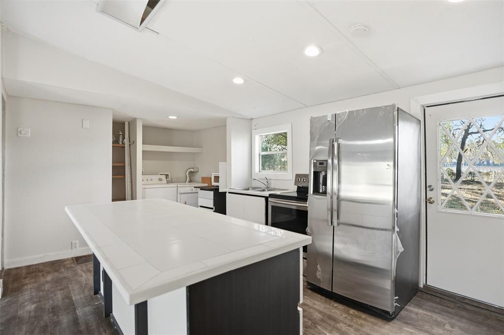 25256 Richbarn Road Brooksville, FL 34601 - Photo 10 of 32 a kitchen with refrigerator and chairs