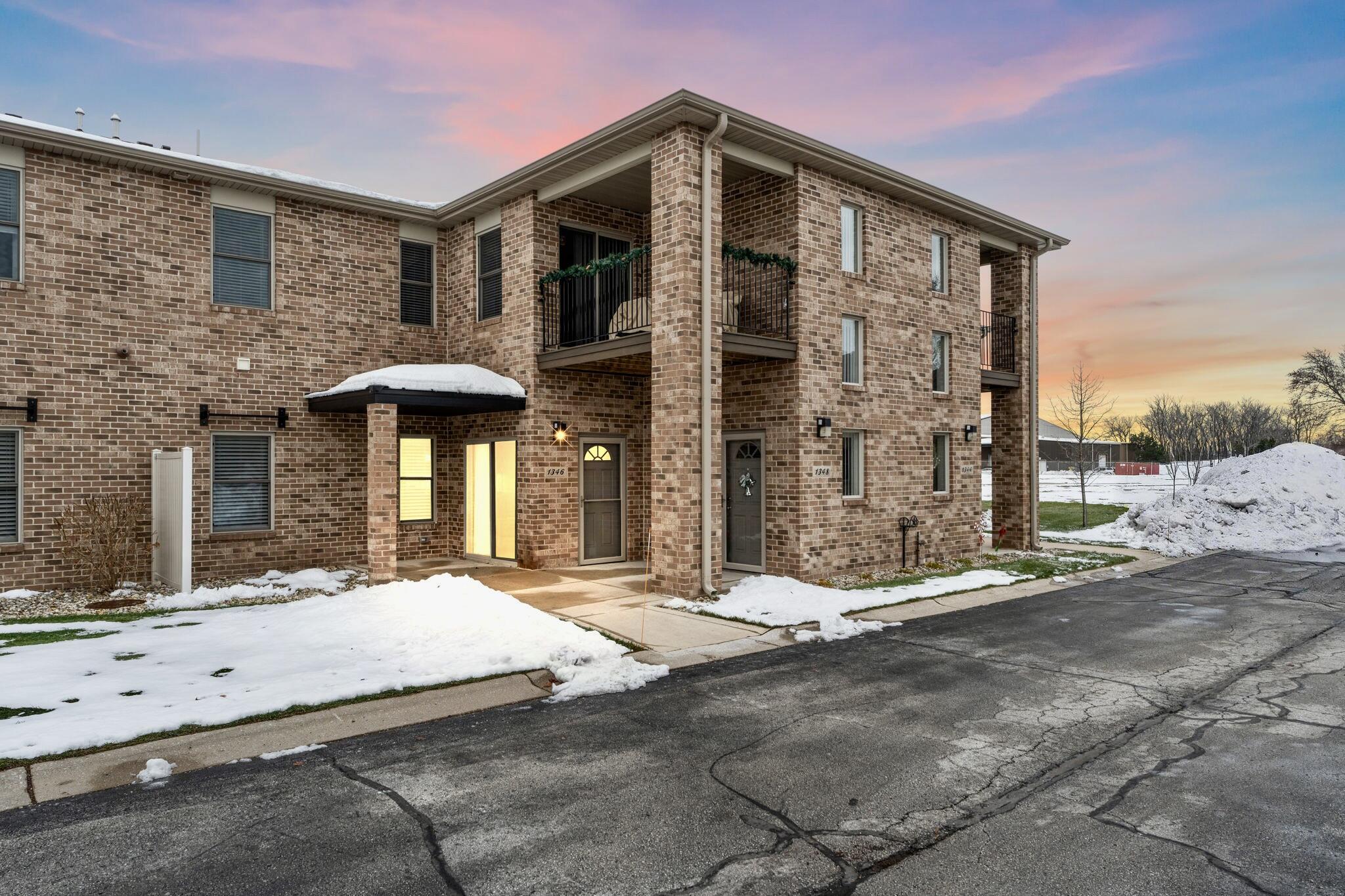 a front view of a building with a garden