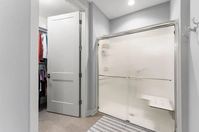 a bathroom with a glass shower door