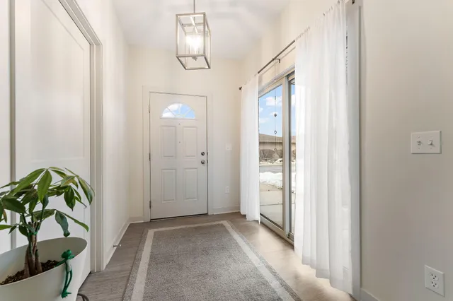 a view of an entryway with wooden floor
