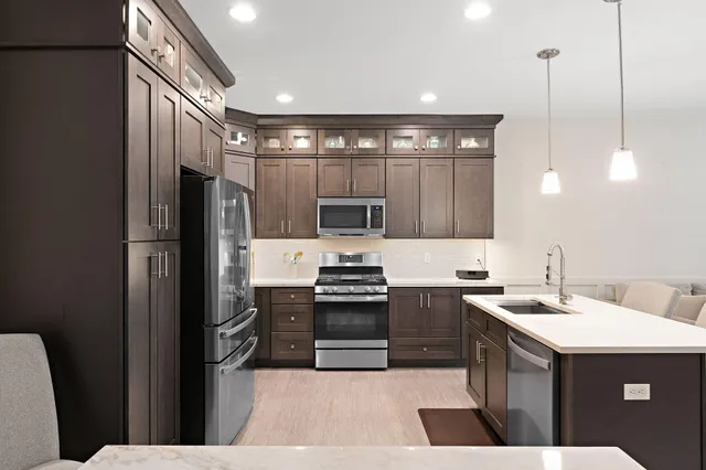 a kitchen with a sink stainless steel appliances and cabinets