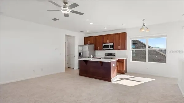 a large kitchen with stainless steel appliances granite countertop a stove sink and cabinets