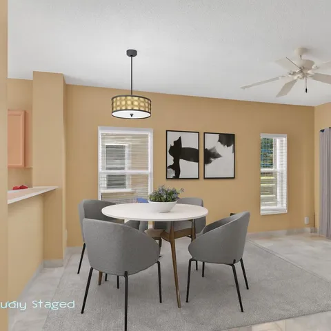 a dining room with furniture and window