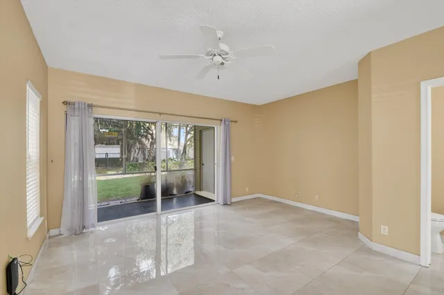 a view of a room with a window and a ceiling fan